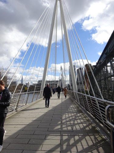 Golden cross bridge, a pedestrian walkway, and looking across the River Thames, in March 2020