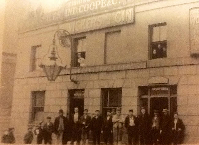 The picture is of the Fishing Smack pre 1899 before the boiler explosion. The man in the bowler hat is the landlord, Henry Seabrook. I have been told that one of the three ladies in the window above is his wife, and the other two her sisters. One of the little boys on the left is my grandfather, James G Blyth.