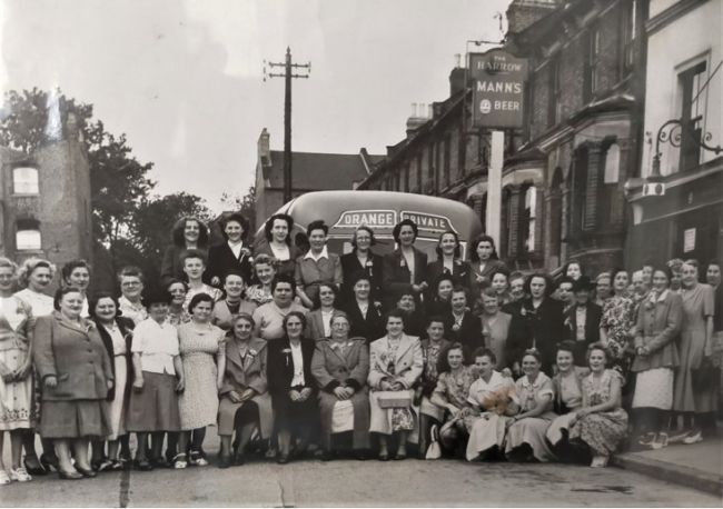 A ladies outing outside the Harrow, 17 Lettsom Street, Camberwell, a Manns Pub and and Orange bus